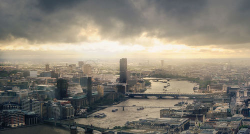 High angle view of cityscape against cloudy sky