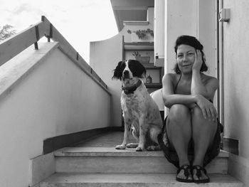 Portrait of dog sitting on staircase