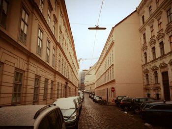 Vehicles on road along buildings