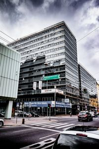 Vehicles on road against buildings in city