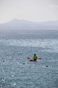 Man paddleboarding in sea