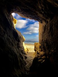 Scenic view of sea seen through cave