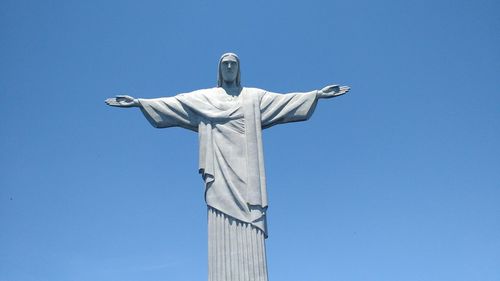 Low angle view of christ the redeemer statue against clear blue sky