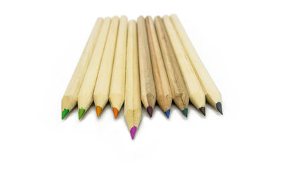 Close-up of multi colored pencils against white background