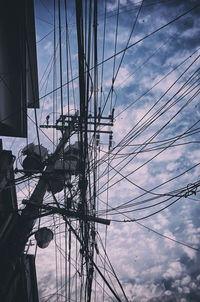 Low angle view of electricity pylon against sky