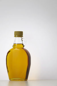 Close-up of agave syrup against white background