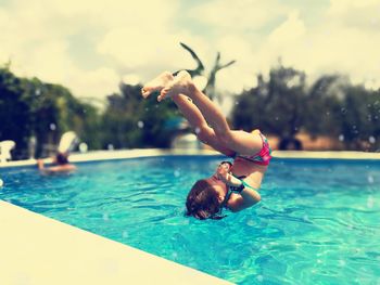 Girl jumping in pool
