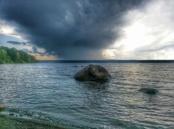 Scenic view of sea against cloudy sky