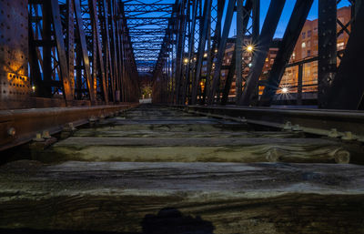 Surface level of illuminated bridge at night