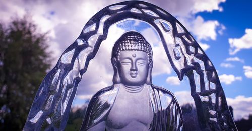 Low angle view of statue against sky