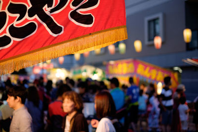 Crowd at illuminated city at night