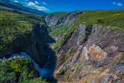 Scenic view of waterfall against sky