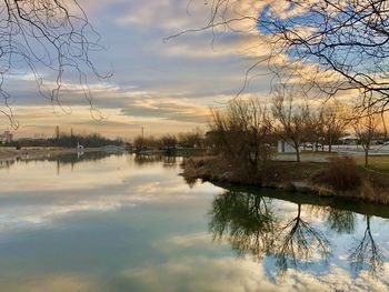 Scenic view of lake against sky at sunset