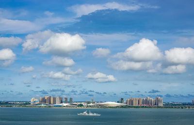 Scenic view of sea by buildings against sky