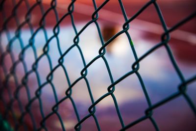 Full frame shot of chainlink fence against sky