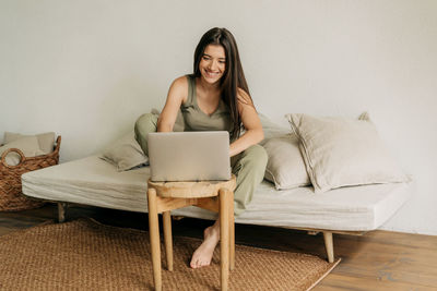 Young woman using laptop at home