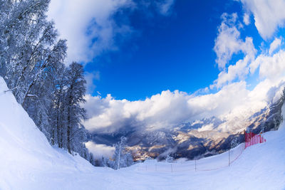 Scenic view of snow covered mountains against sky