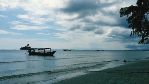 Boat moored on sea against sky