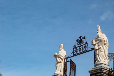 Low angle view of statue against blue sky