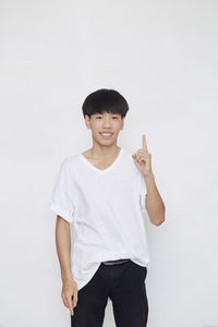 Portrait of smiling man standing against white background