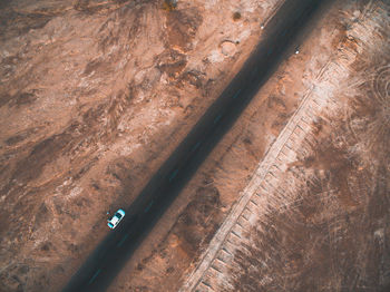 Aerial view of car on road amidst arid landscape