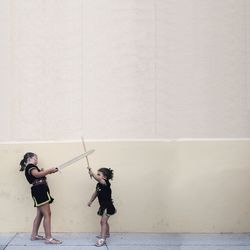 Full length of woman standing by railing