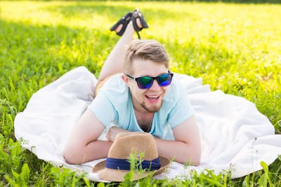 Man wearing sunglasses on grassy field