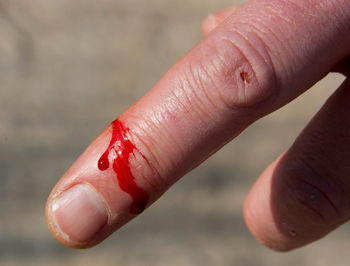 Close-up of hand holding red finger