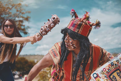 Representation of inca warrior dressed and with battle, prehispanic fighting with a tourist in peru