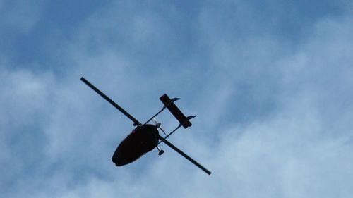 Low angle view of airplane flying in sky