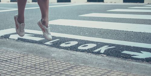 Low section of person on zebra crossing