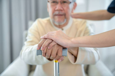 Midsection of man holding syringe