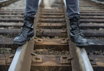 Low section of man standing in front of ladder