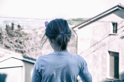Rear view of woman looking at building