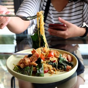 Close-up of person holding food on table