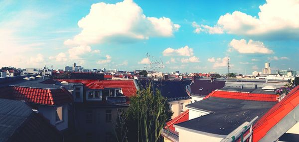 Residential buildings against cloudy sky