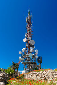 Low angle view of television tower against blue sky