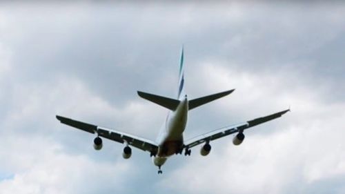 Low angle view of airplane flying against sky