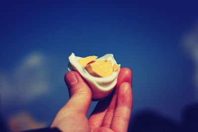 Cropped image of hand holding boiled egg