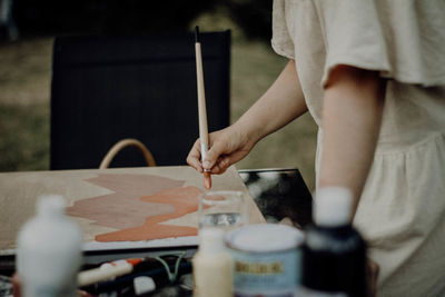 Midsection of man working on table