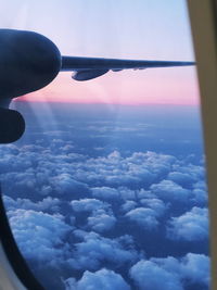 Aerial view of clouds seen through airplane window