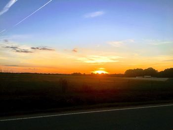 Scenic view of field against sky during sunset