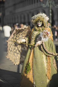 Woman wearing costume on street in city during carnival