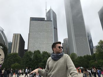 Low angle view of woman standing against buildings