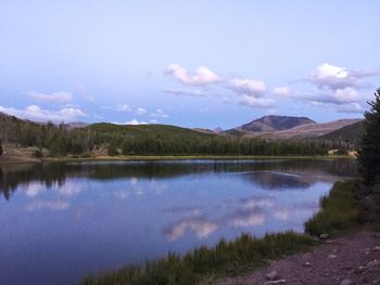 Scenic view of lake and mountains against sky