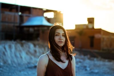 Portrait of woman standing against water