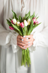 Close-up of woman holding bouquet of pink tulip