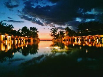 Scenic view of illuminated trees against sky at sunset