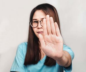 Portrait of young woman against white background