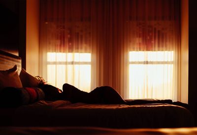 Woman relaxing on bed at home